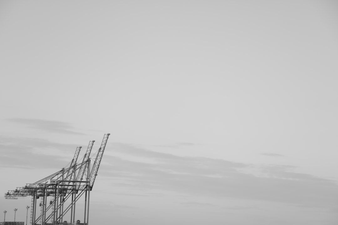 Un casco de construcción sobre planos digitales con gráficos de análisis predictivo de riesgos generados por inteligencia artificial.