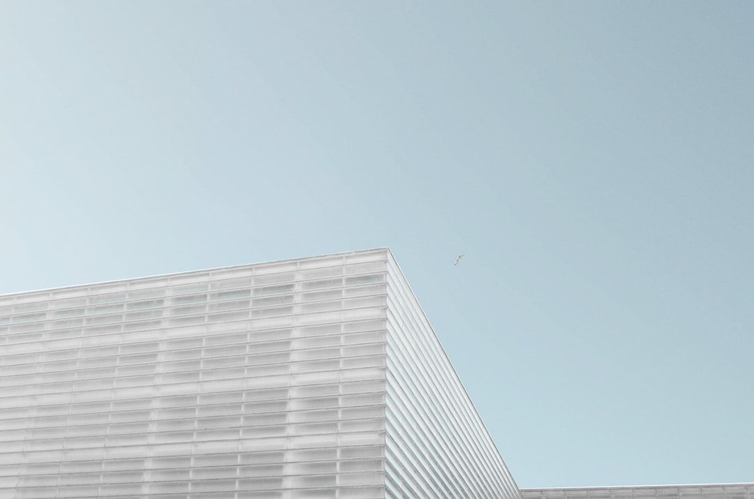 grey concrete building under clear blue sky