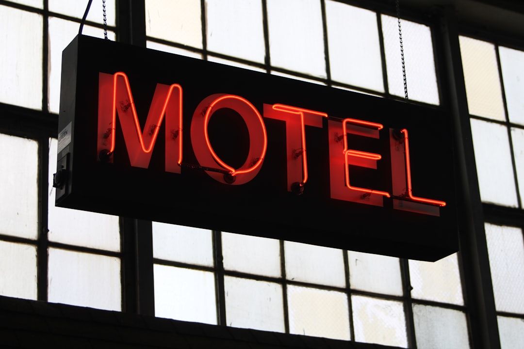 a neon sign hanging from the side of a building